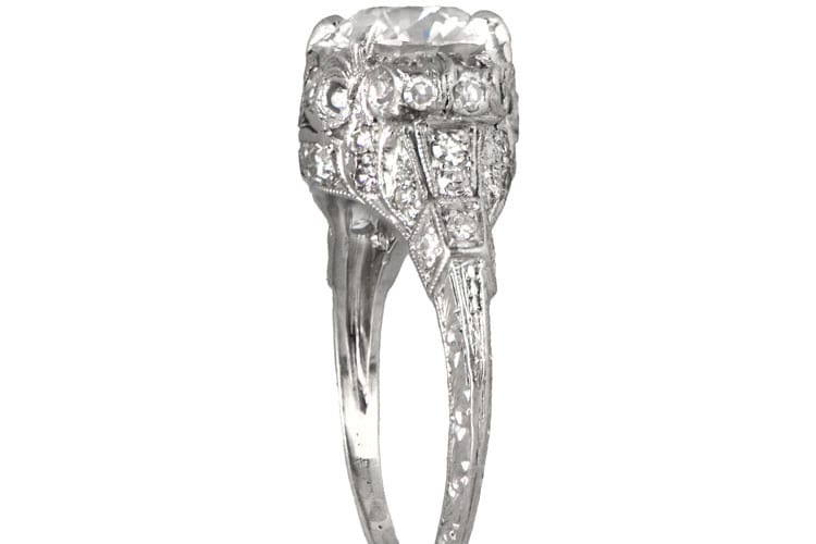 Estate Diamond Jewelry An original Art Deco platinum engagement ring with 2.01-carat old European cut diamond, the ring is further decorated with a scroll motif along the shoulders and filigree. Diamonds are set throughout the details, circa 1920. (Photo courtesy of Estate Diamond Jewelry)