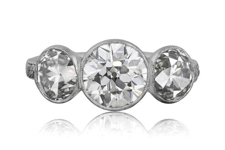 Three-stone bezel-set diamond ring set in platinum and exhibiting antique-cut diamonds. Photo courtesy of Estate Diamond Jewelry.