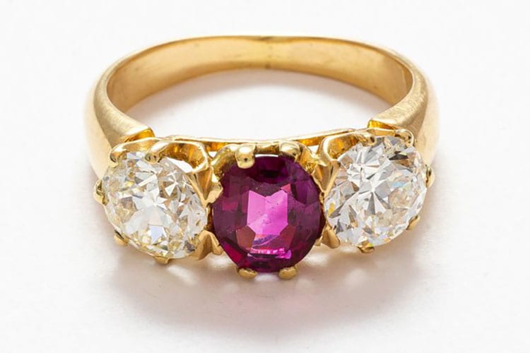 Gray & Davis 14K yellow gold early Edwardian three stone ring of European cut diamonds and center oval ruby.