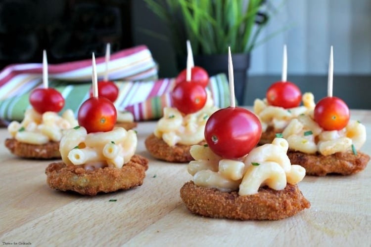Fried pickles toped with mac and cheese and cherry tomatoes on toothpicks