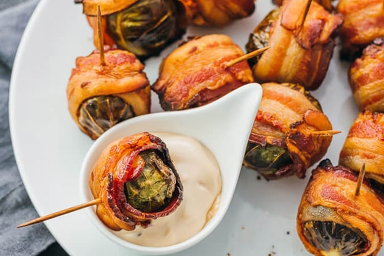 Plate of roasted Brussels sprouts wrapped in bacon