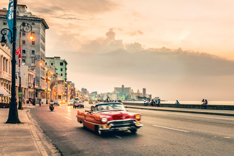 An old convertible driving along the streets of Havana